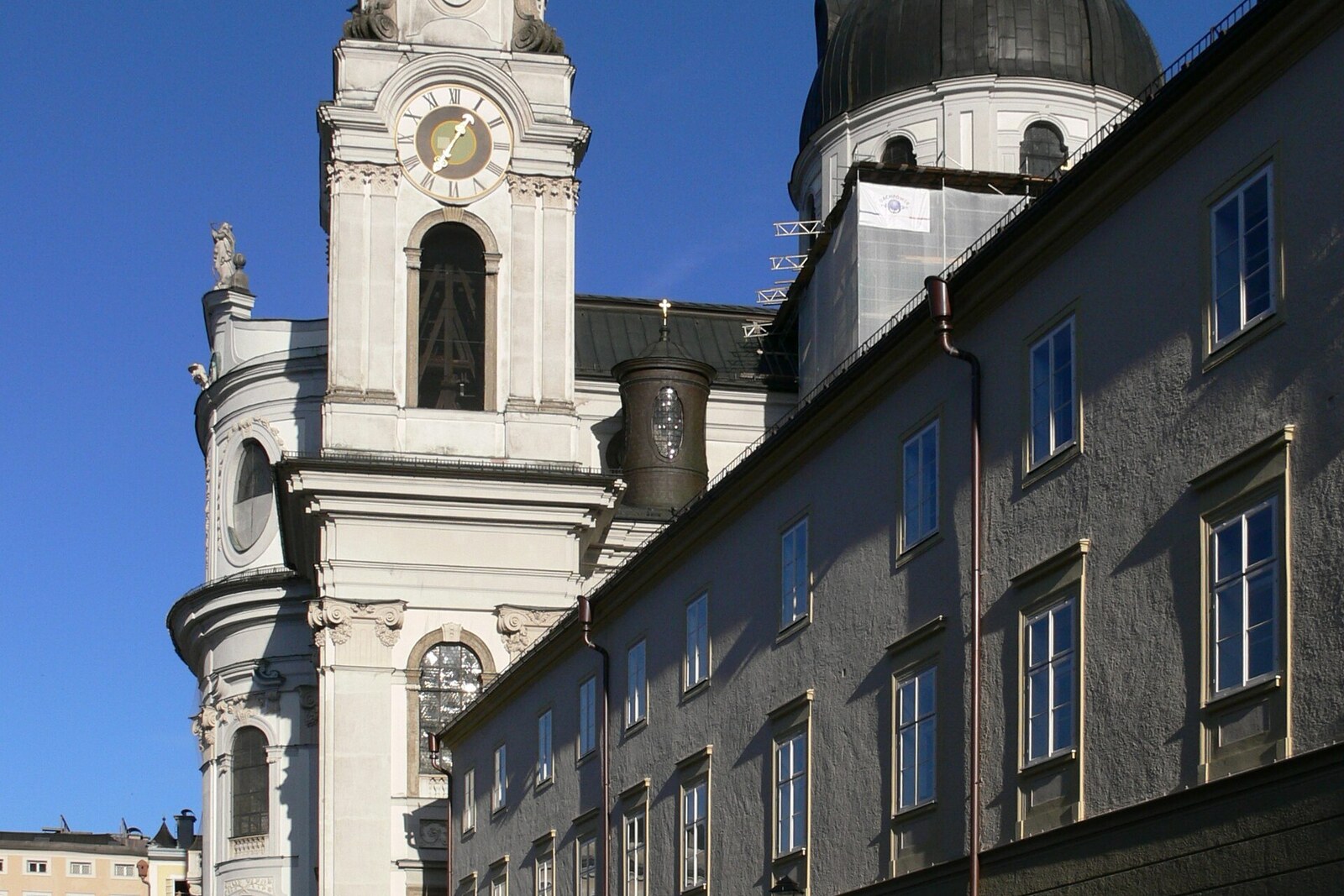 A large square with a Baroque church and historic buildings