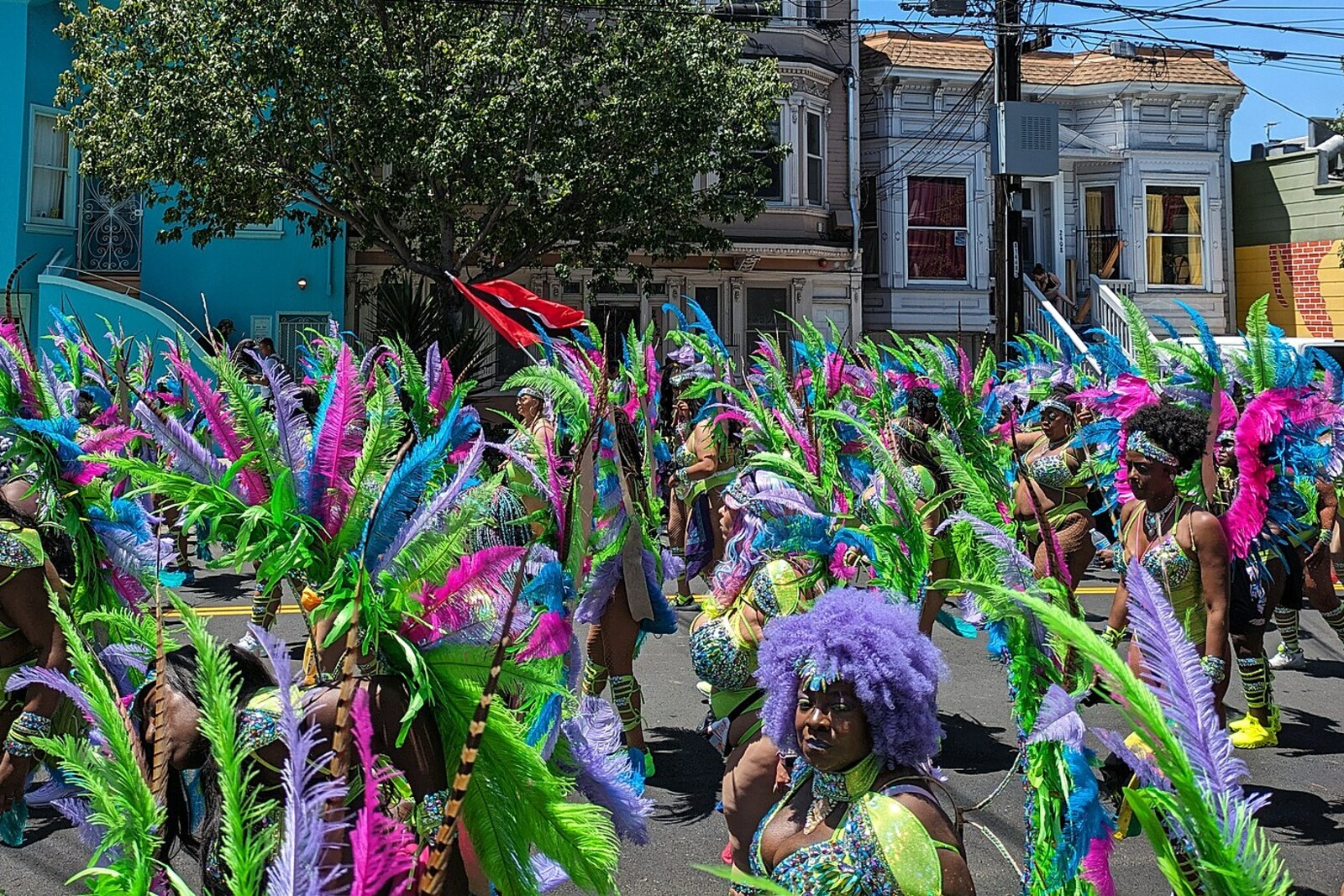 Participants in Carnaval San Francisco with a Trinidad and Tobago flag in the Mission District.
