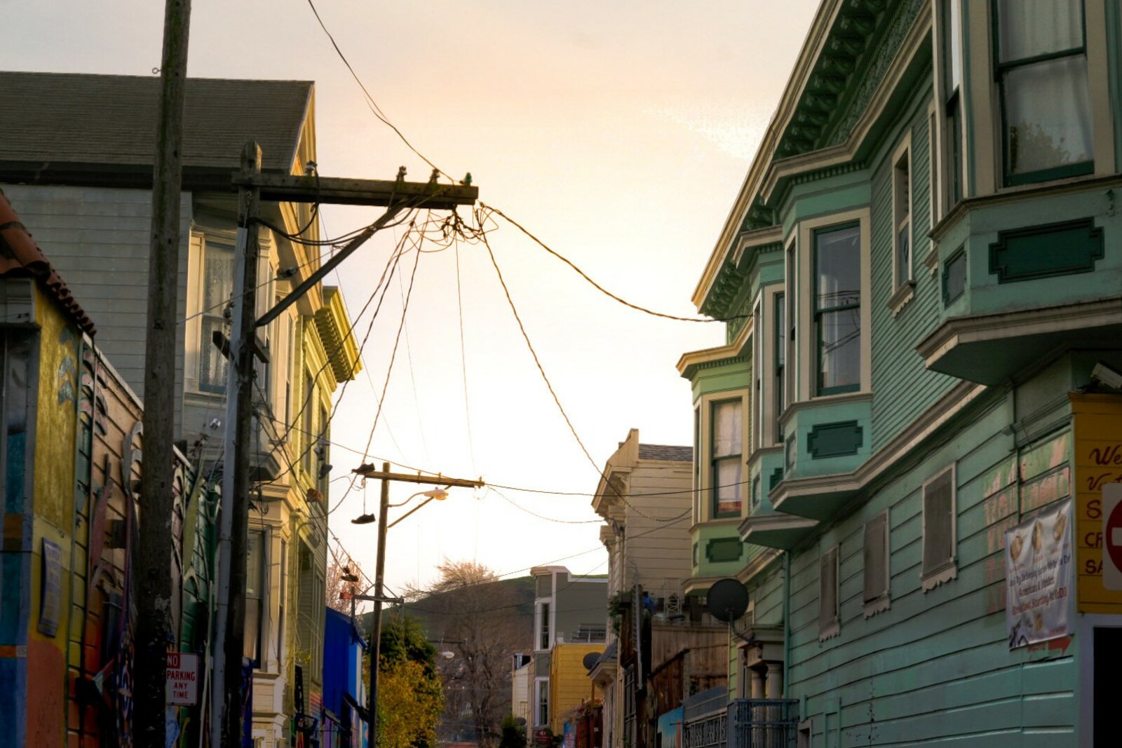 View of Balmy Alley at dusk, with a broad context of the street and facades.