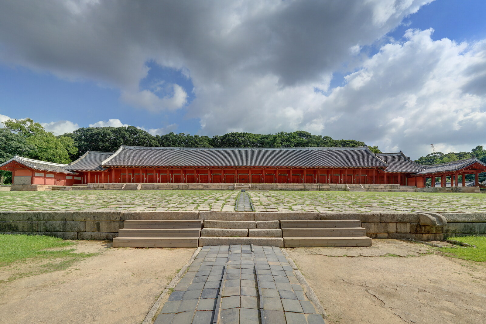 The long Jeongjeon Hall main hall before the broad stone courtyard of Jongmyo Shrine.