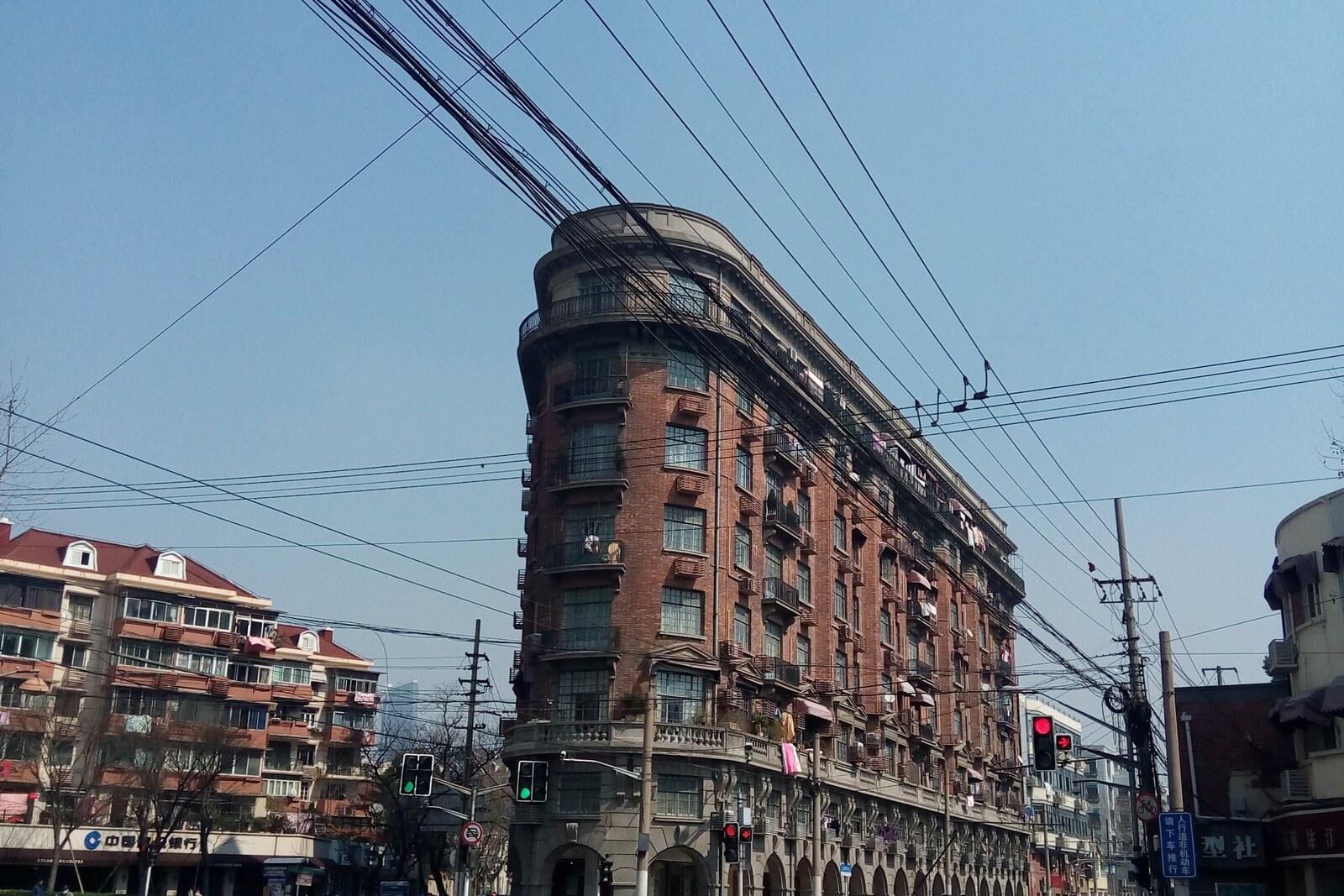 Wukang Mansion, a wedge-shaped early modernist building with many balconies