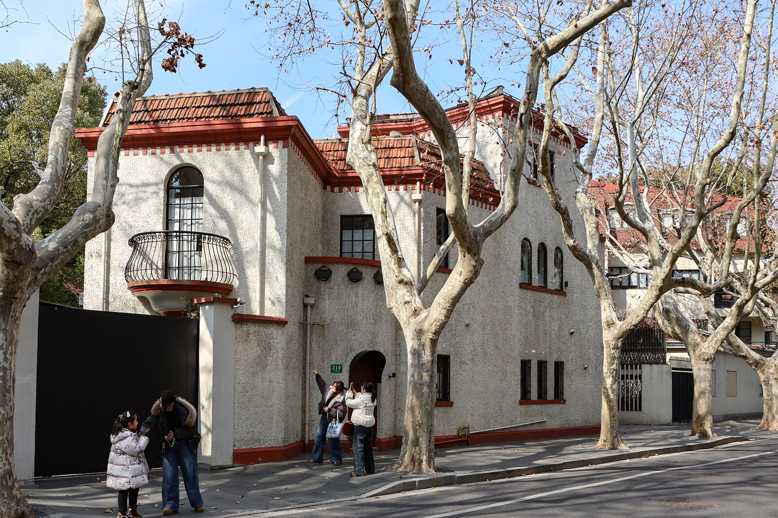 House No. 210 on Wukang Road, with the balcony known as the Romeo Balcony, beneath plane trees.