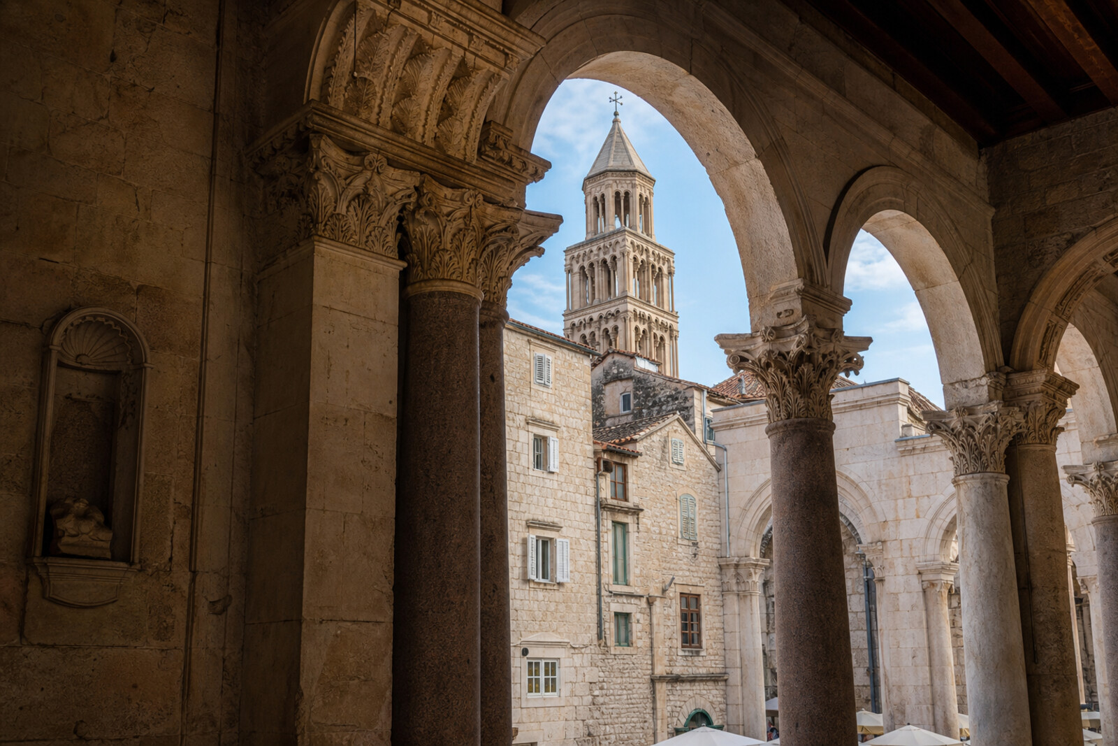 Stone arches of Diocletian's Palace and the bell tower of St. Domnius Cathedral in Split