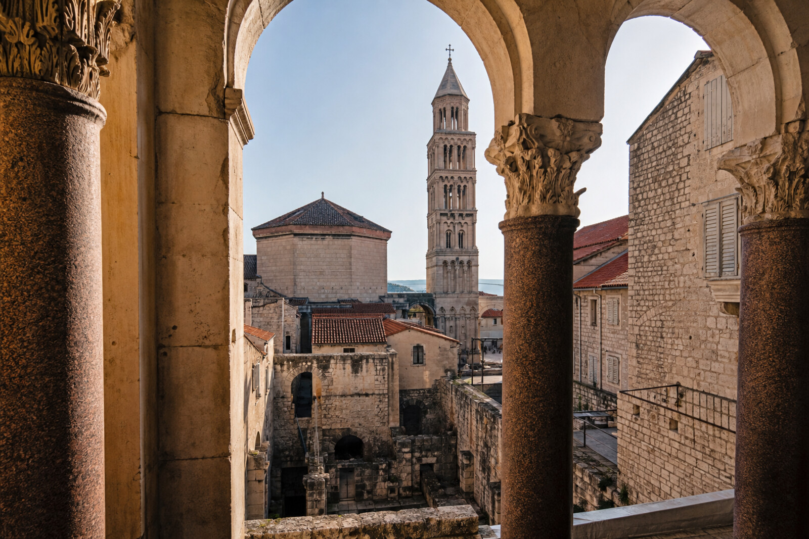 Arches of the Peristyle, the mausoleum with its bell tower, residential windows, and the vaults of the Palace Substructures on a route through a palace that became a city.