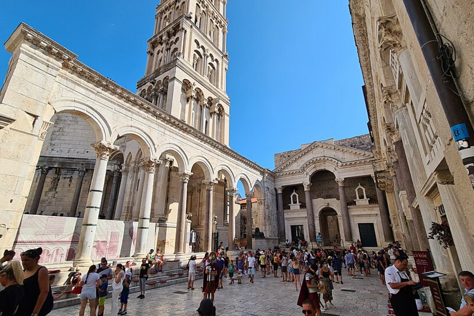 The Peristyle of Diocletian's Palace with red granite columns and a tall central arch.