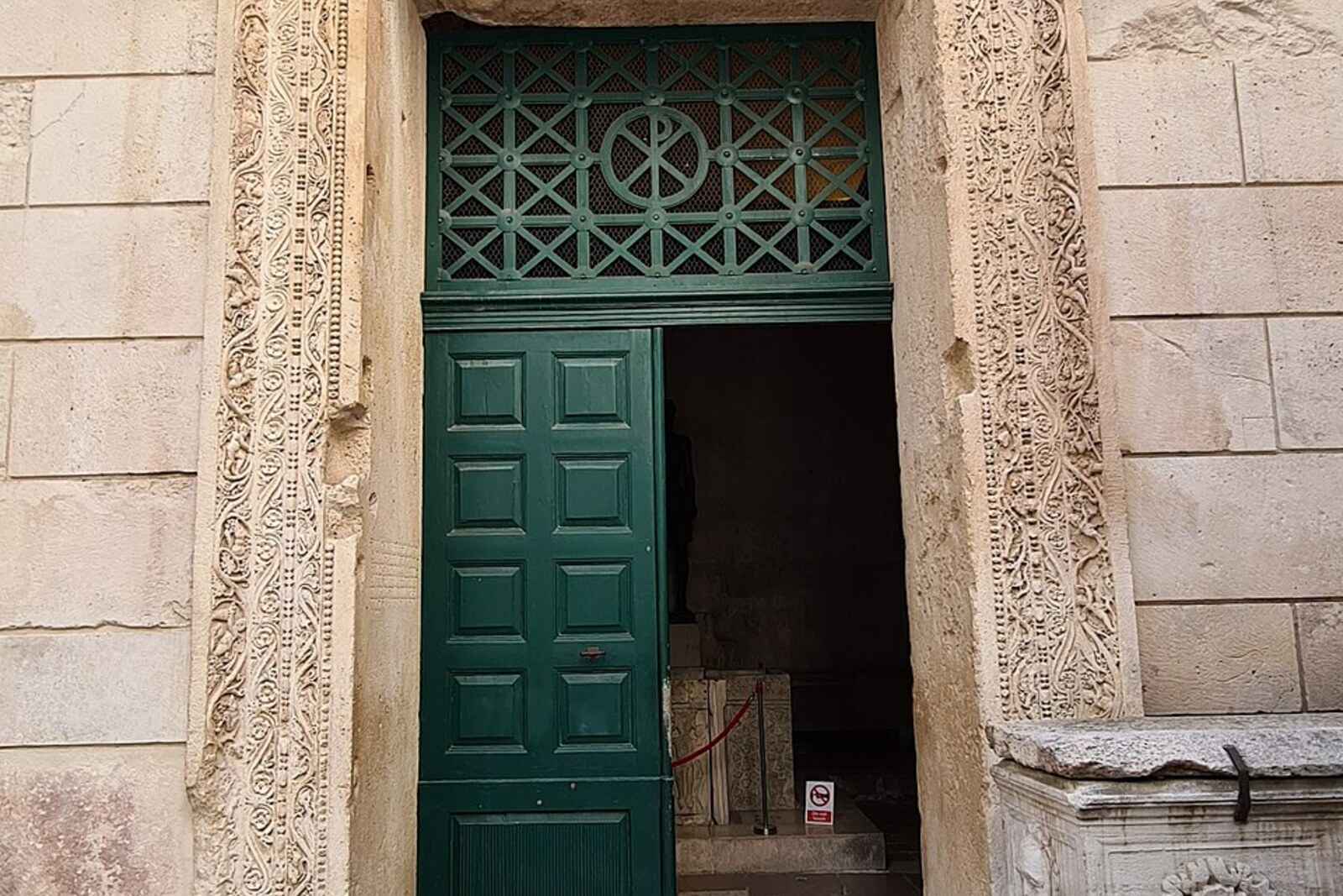 The carved portal of the former Temple of Jupiter, with a stone coffered vault inside.