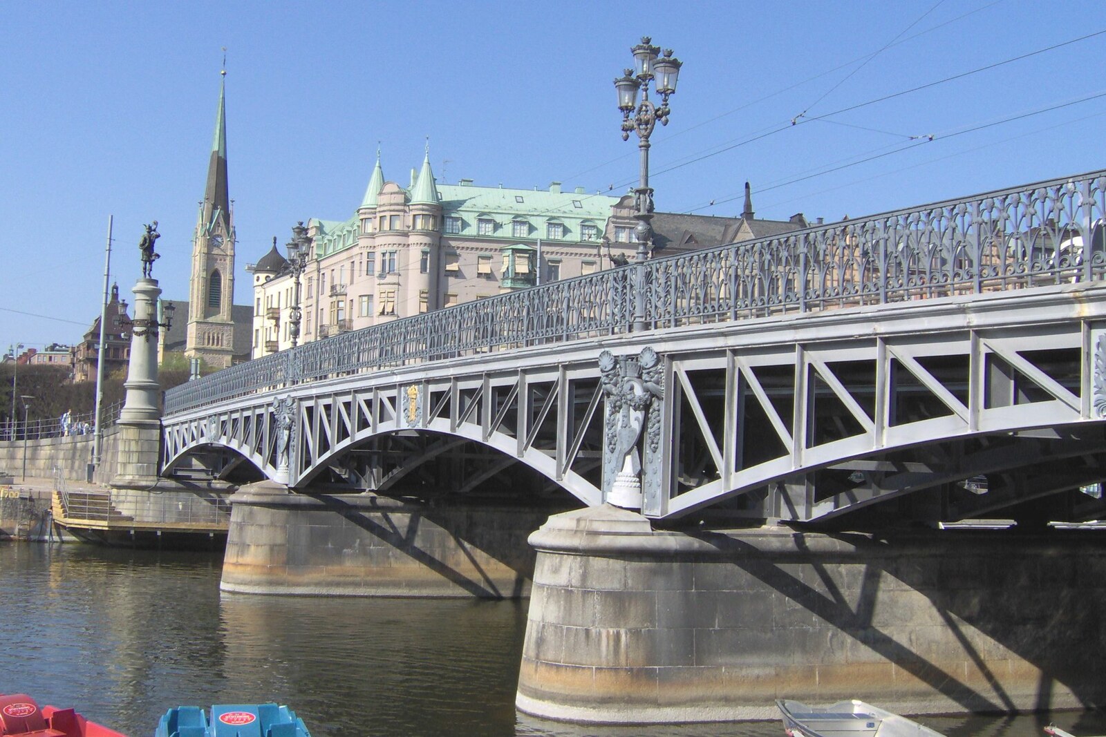 View of the statue-decorated Djurgårdsbron bridge leading to the green island