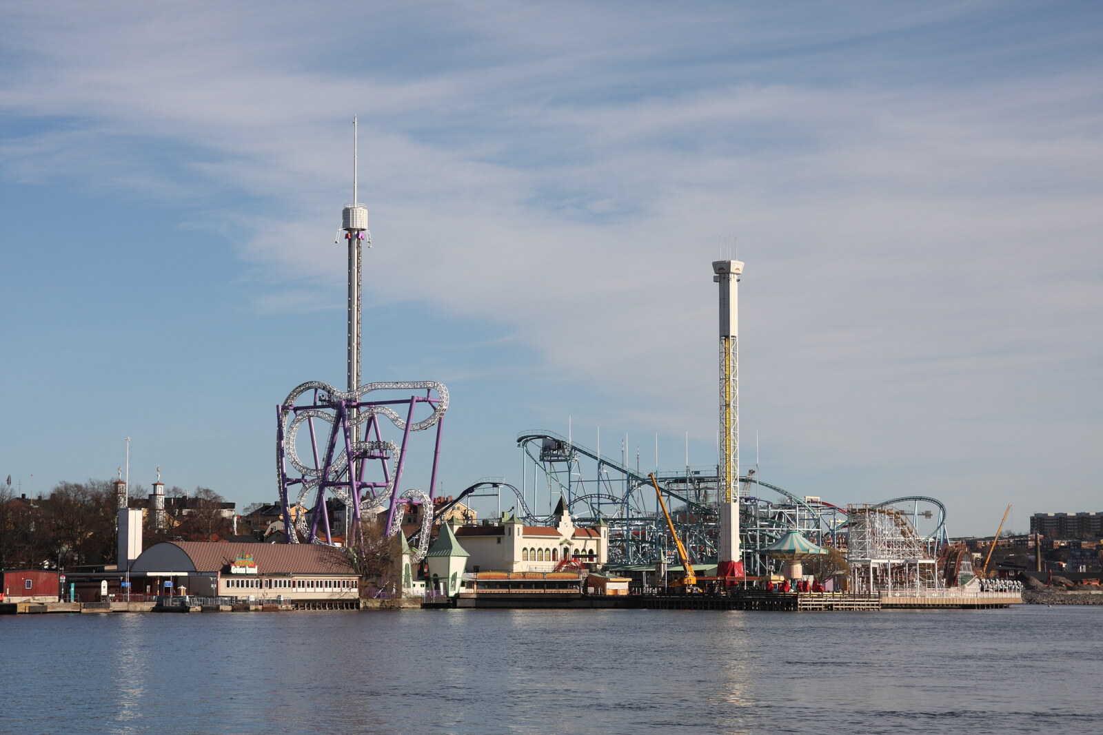 View of the Gröna Lund amusement park with roller coasters and a tower on the waterfront