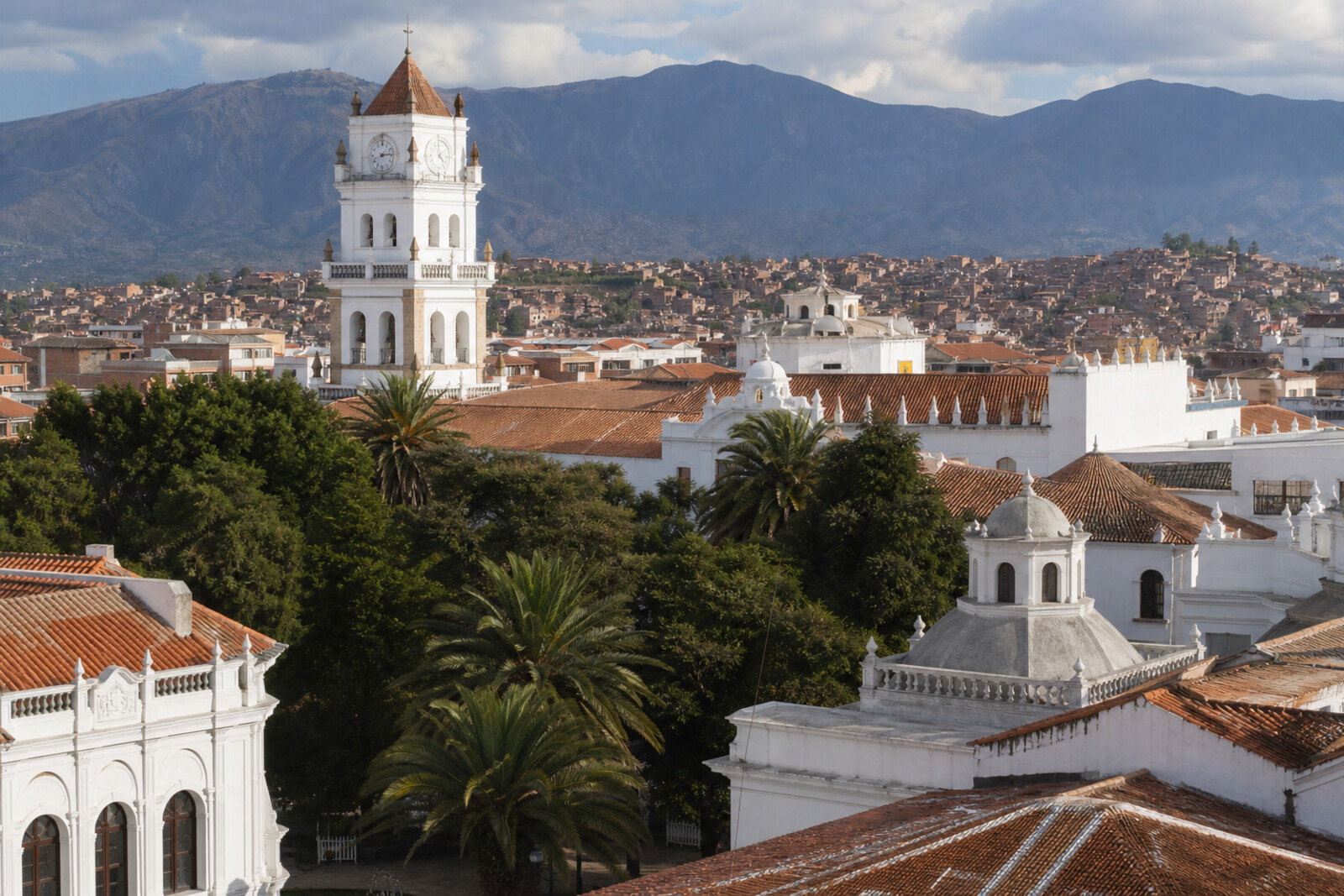 White facades, red tiles, and the cathedral tower in Sucre's historic center.