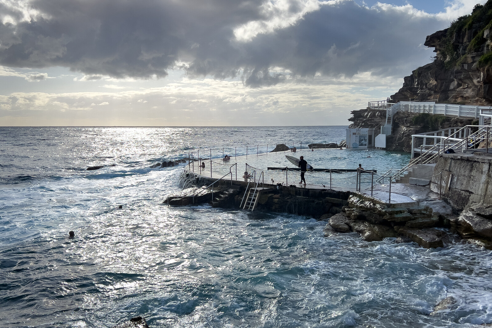The Bronte Baths ocean pool beside rocks and surf on the Sydney coast.