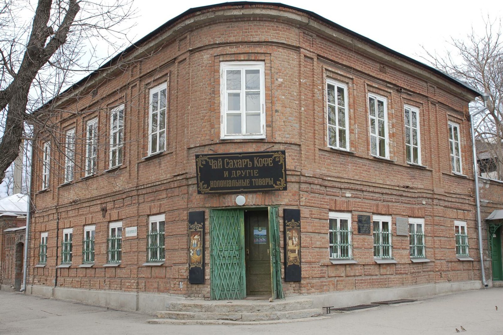 The corner two-story facade of the Chekhov Shop Museum with its historic sign.