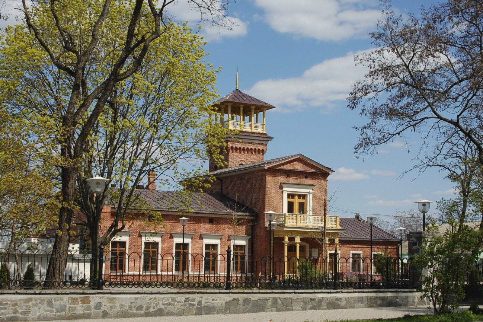Red-brick Tchaikovsky House with a corner tower and a balcony.