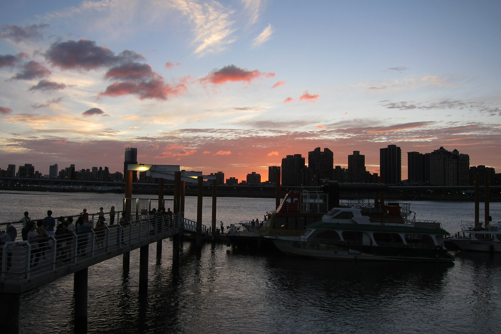 Sunset view of Dadaocheng Wharf and the silhouette of New Taipei across the river.
