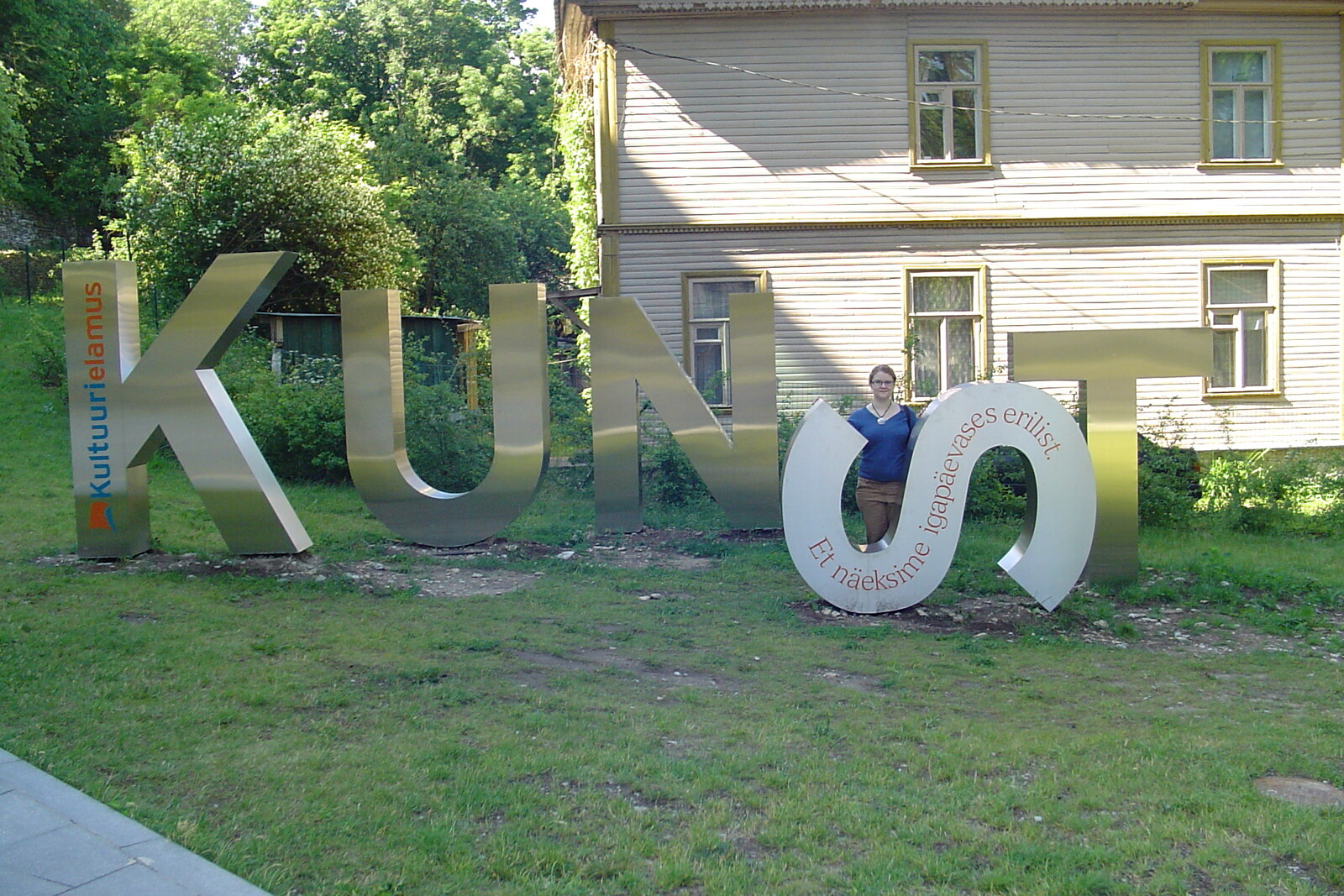 The modern building of Kumu Art Museum and a large sign in front of the entrance