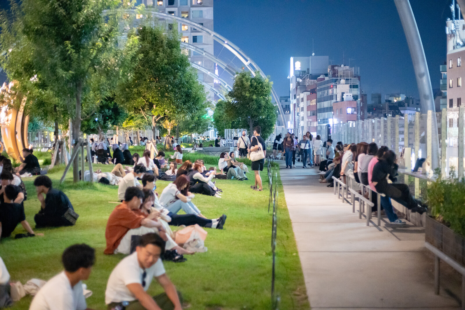 Green Miyashita Park on the roof of a shopping complex, with a lawn and a canopy