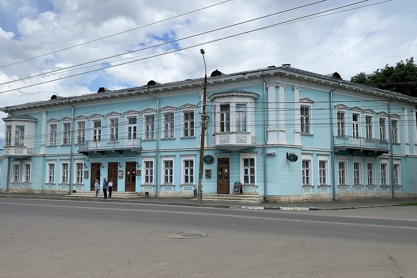 The two-story Pozharsky Hotel, with a stone lower level and a light-colored upper level.
