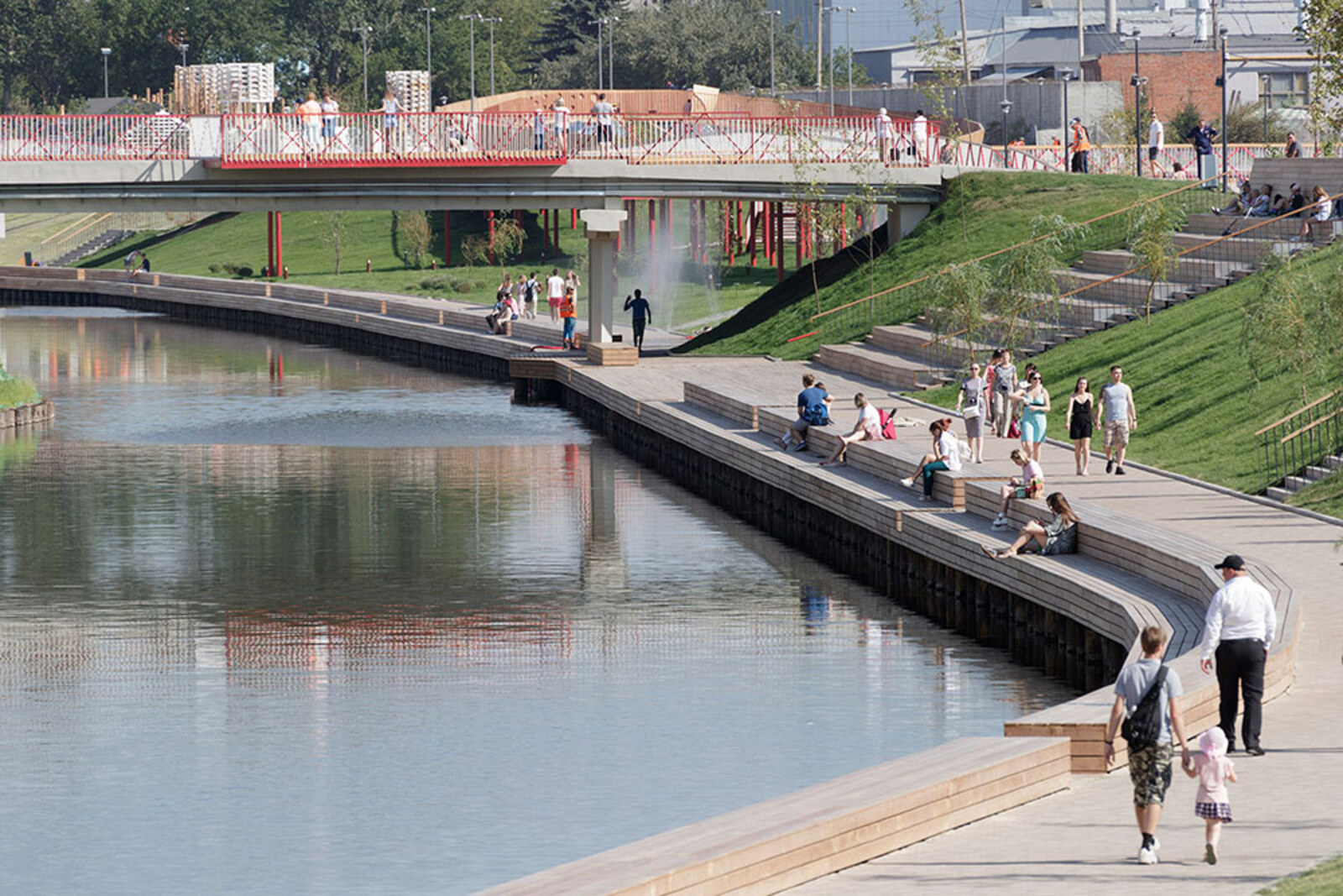 The wooden promenade of Kazan Embankment along the water, bridges, and green slopes.