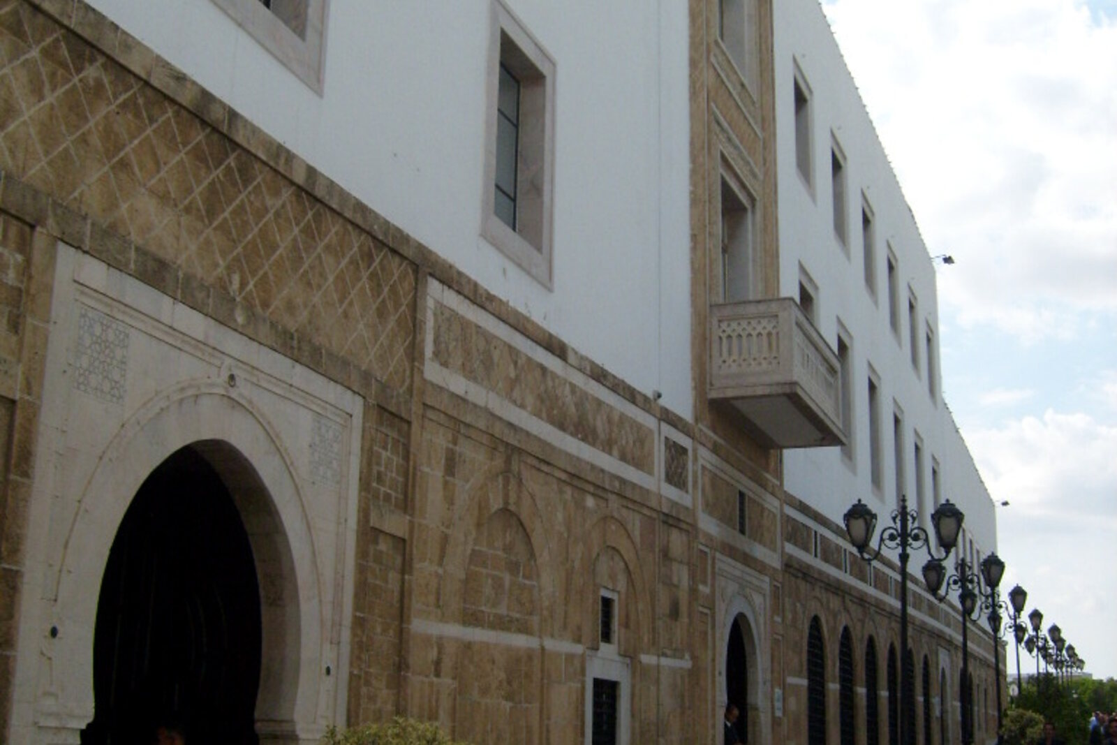 The white facade of Dar el Bey, with its green roof and the open space in front of it.
