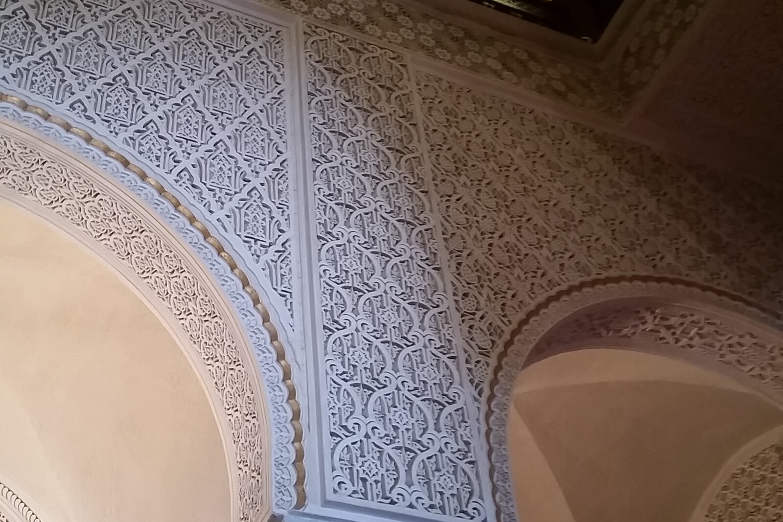 Interior of Ennejma Ezzahra palace with arches and columns.