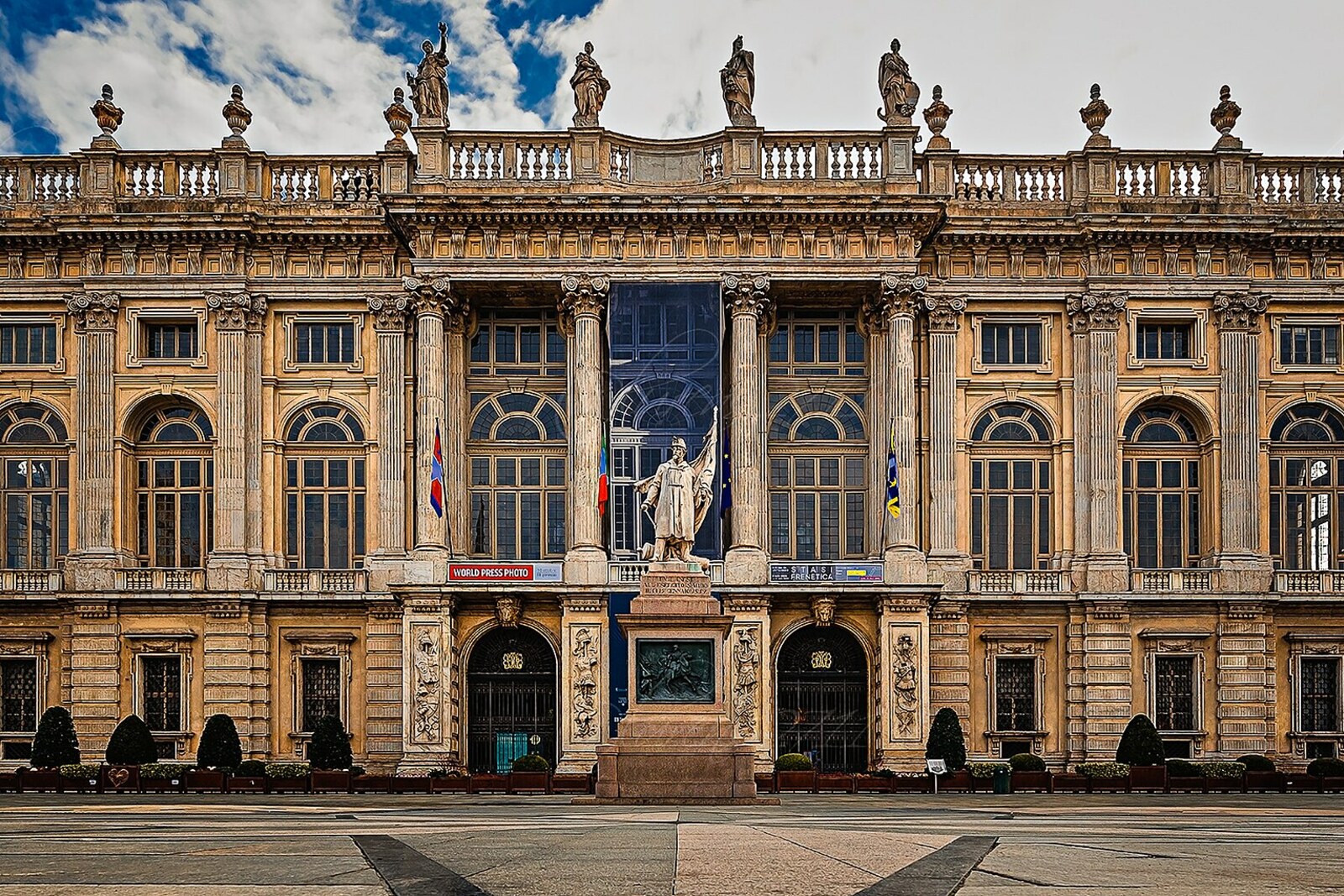 Palazzo Madama: white Baroque facade and brick towers.