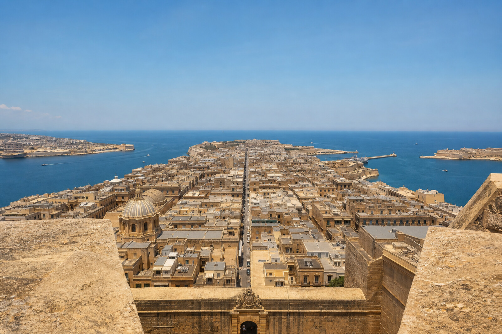Valletta's grid of stone streets leads from City Gate (Bieb il-Belt) to Fort St Elmo between bastions and harbours.