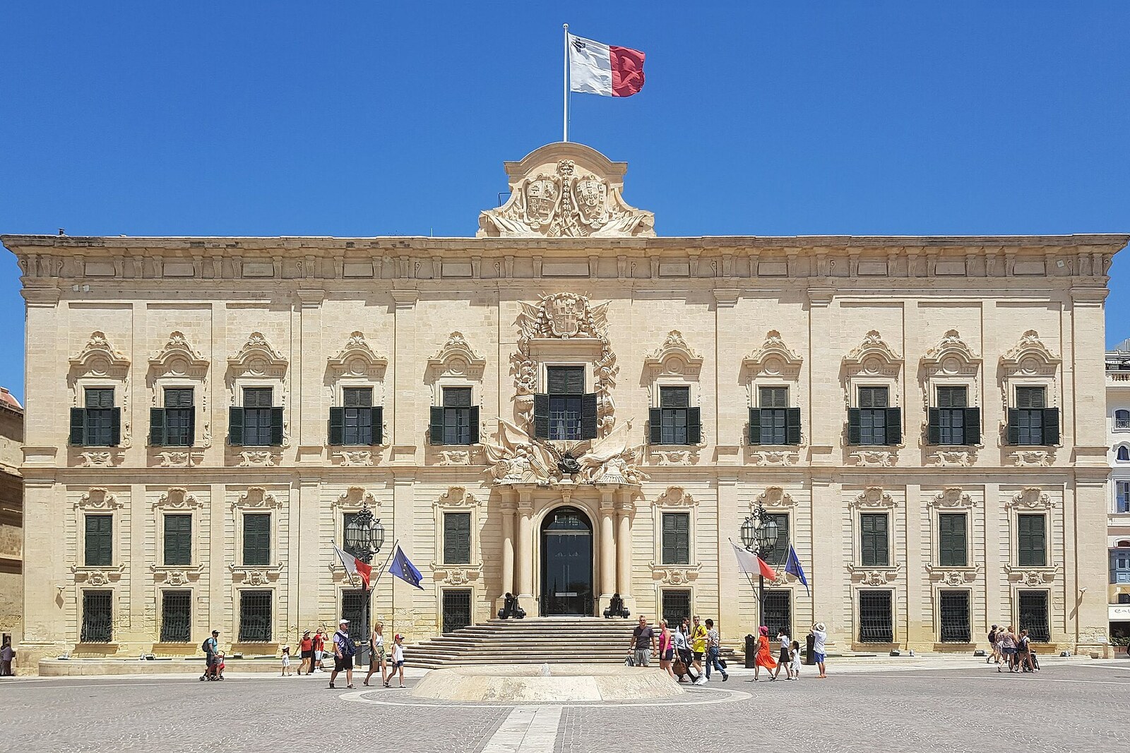 The Baroque façade of Auberge de Castille, Léon and Portugal, with a central entrance and an armorial crest above.