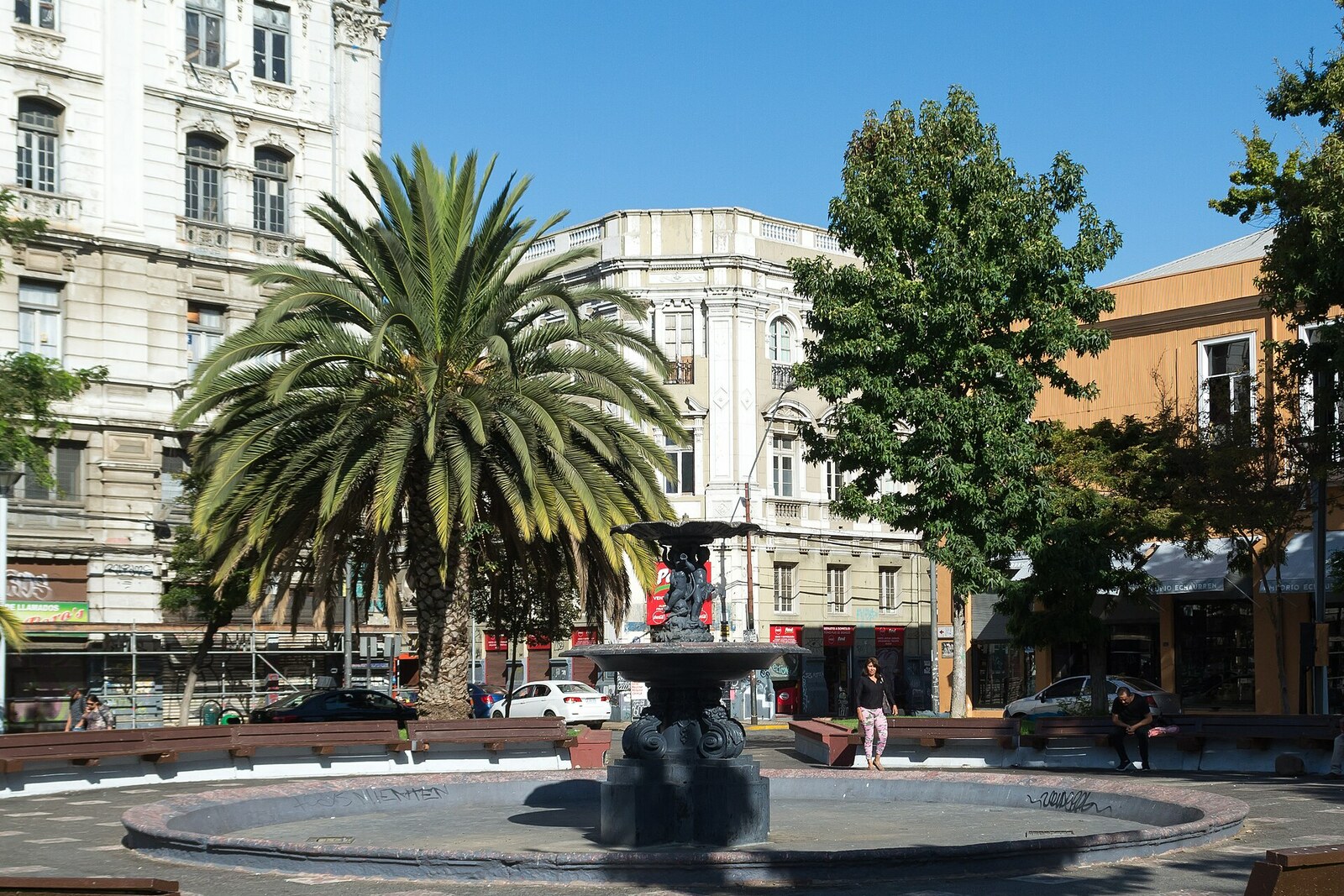 Echaurren Square with a fountain and historic facades around it.