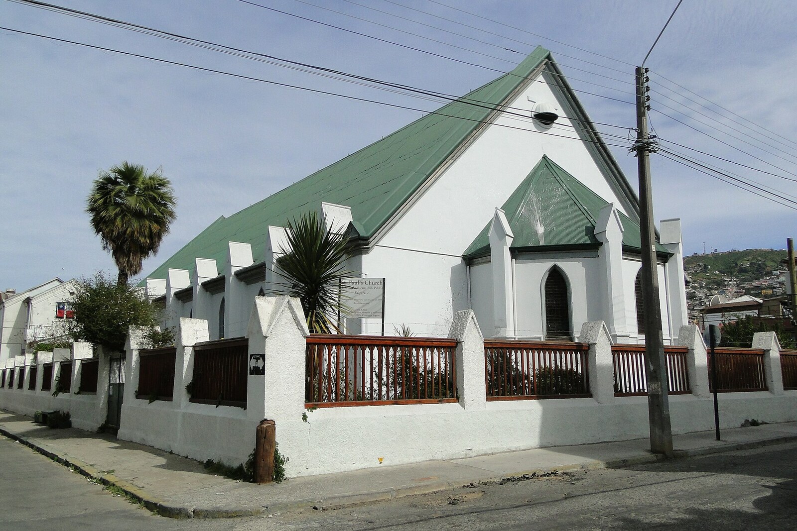 St. Paul's Anglican Church, with a low white structure and a green roof.