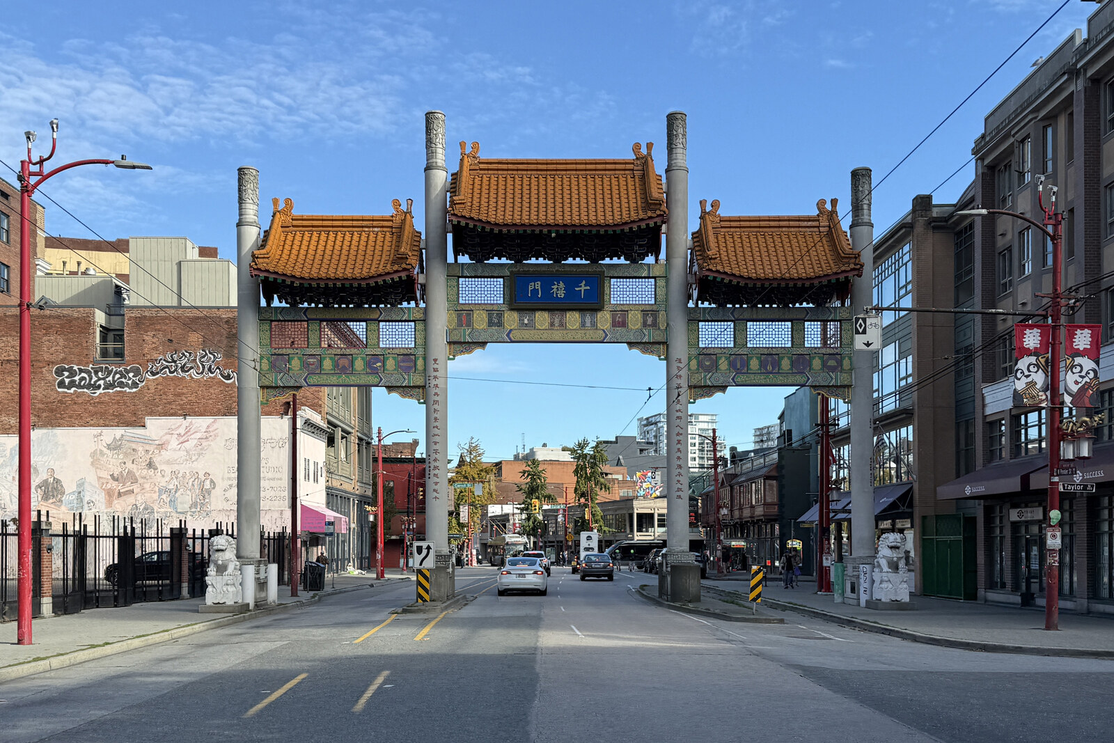 Chinatown’s triple arch with orange roofs and a street in Vancouver