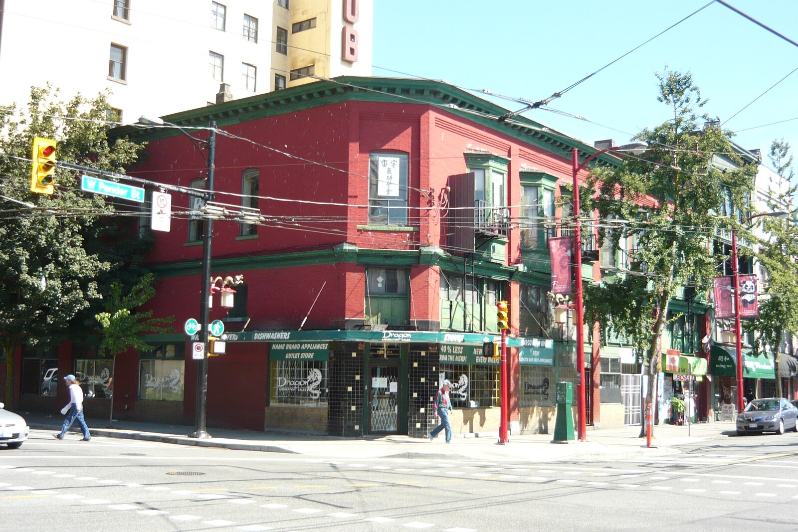 Red-brick facade of the Chinese Times building with white windows and signs