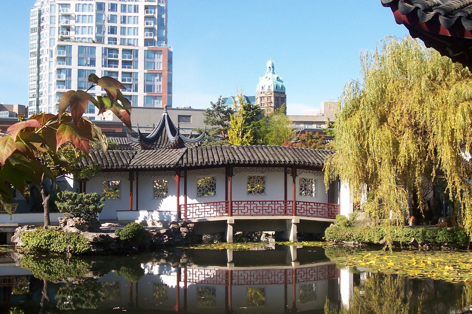 A pond and pavilion in a classical Chinese garden reflected in the water