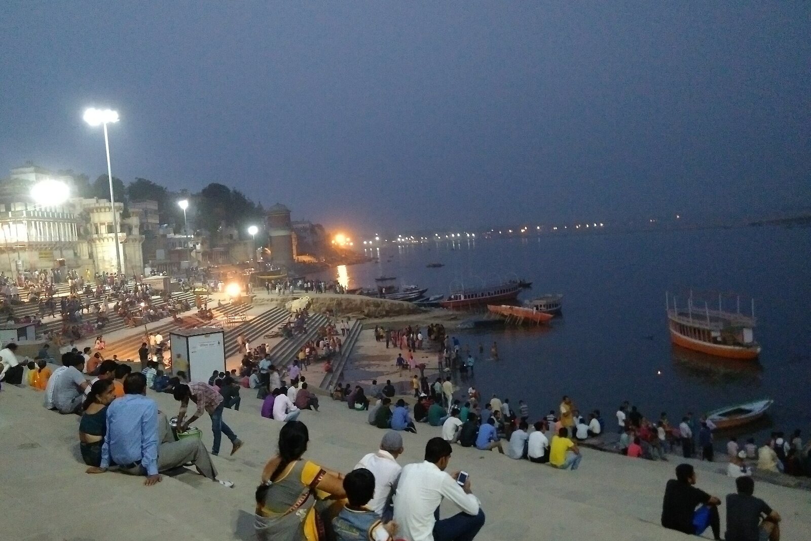 Assi Ghat with wide steps and boats by the water.