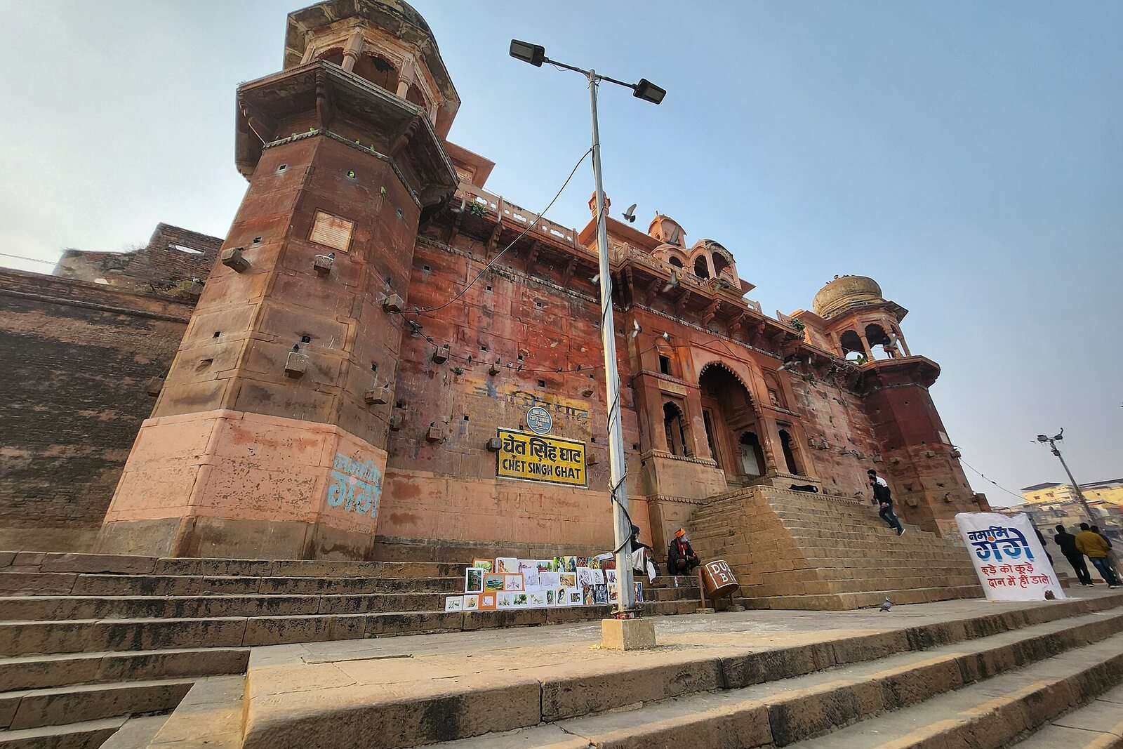 The reddish façade of Chet Singh Ghat above broad steps.