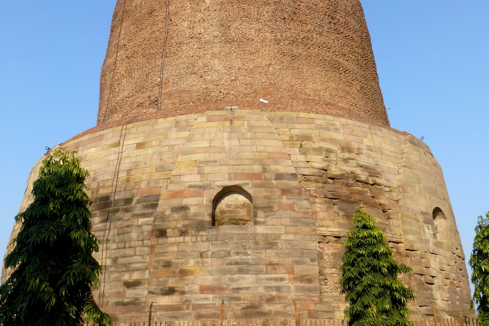 The enormous cylindrical Dhamekh Stupa with stone reliefs and a staircase