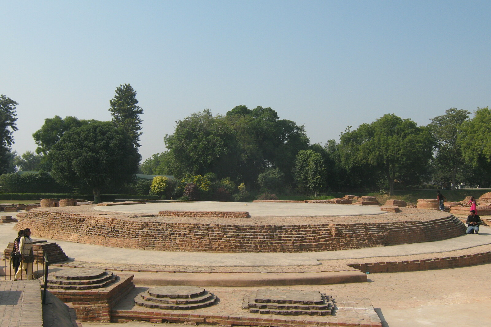 Low circular ruins of Dharmarajika Stupa with a stone railing