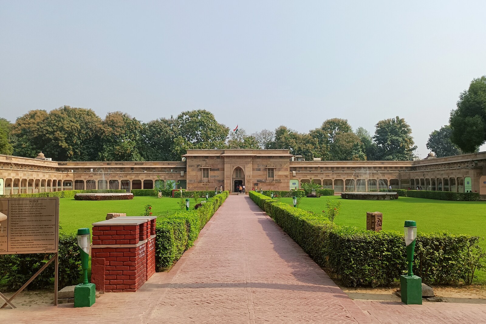 Facade of the Archaeological Museum of Sarnath with columns and a green lawn