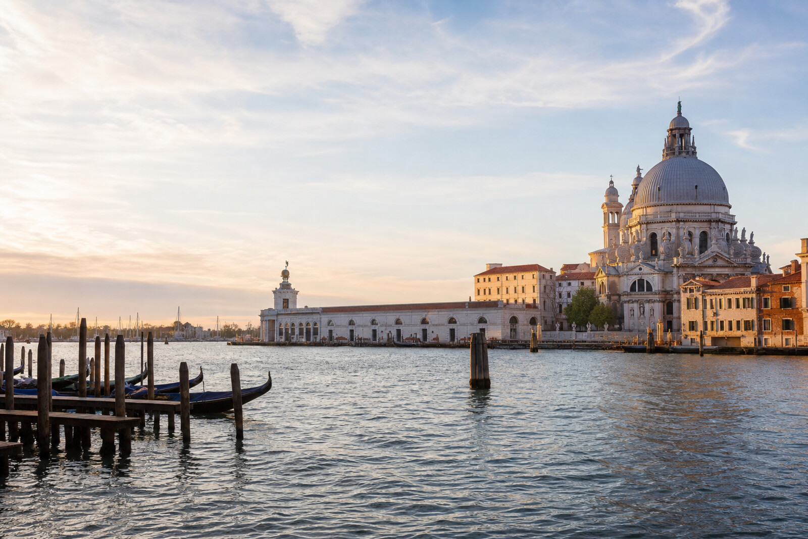 Realistic editorial cover of Dorsoduro by the water: Zattere, Santa Maria della Salute, and Punta della Dogana in the evening light.