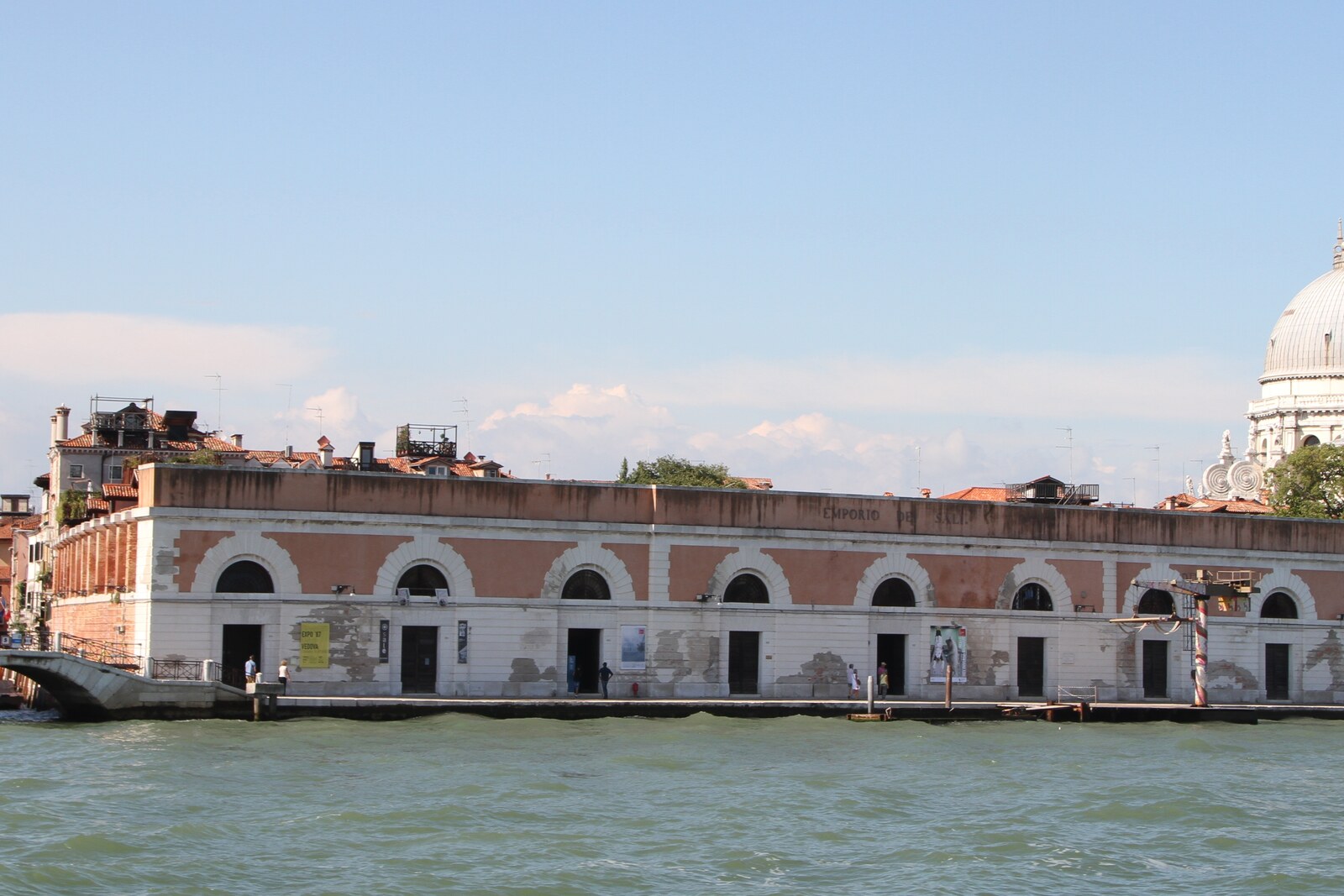 The long facade of Magazzini del Sale on Zattere, with the dome of Santa Maria della Salute in the background.