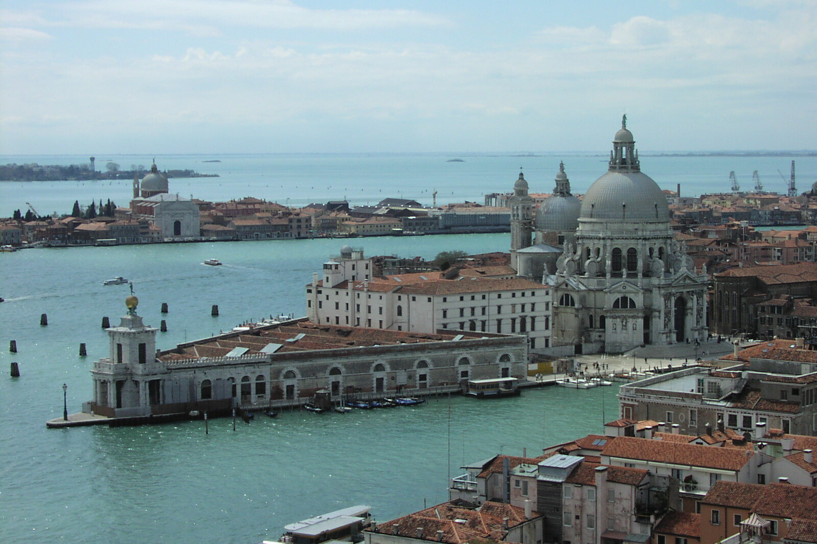 View from the water of Punta della Dogana and the Basilica of Santa Maria della Salute: the white triangular customs house and the church domes.