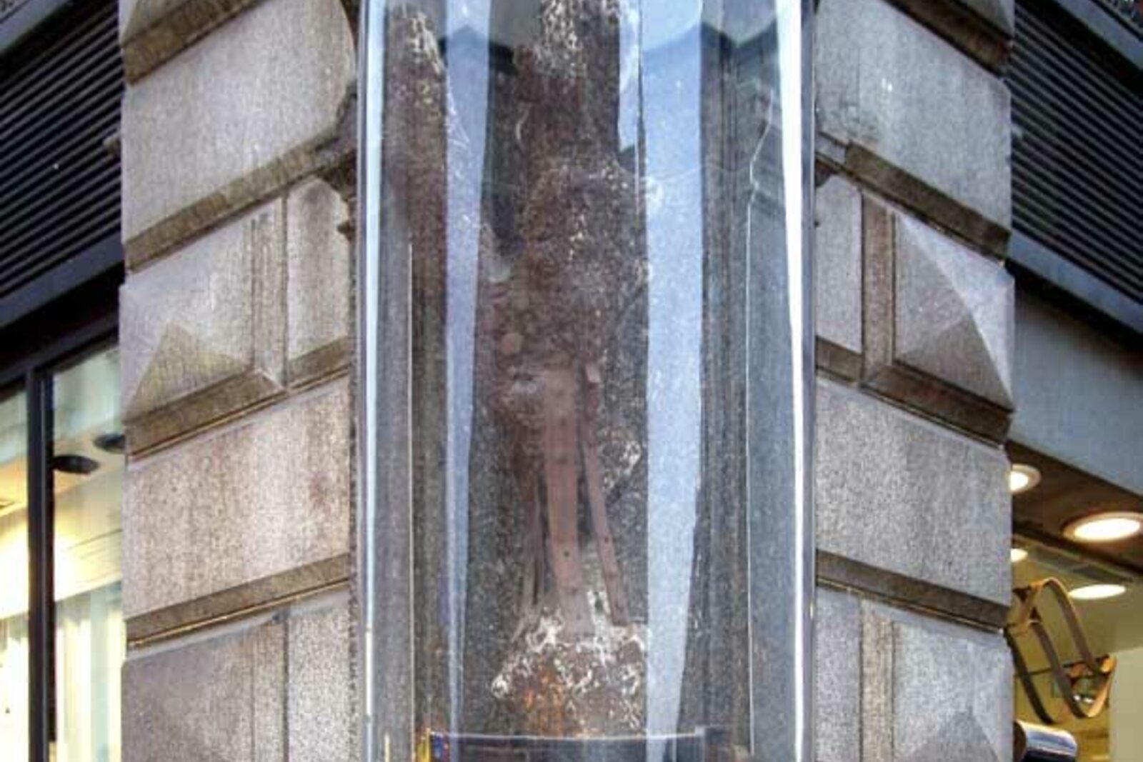 Stock im Eisen behind glass on the corner of Palais Equitable in central Vienna.