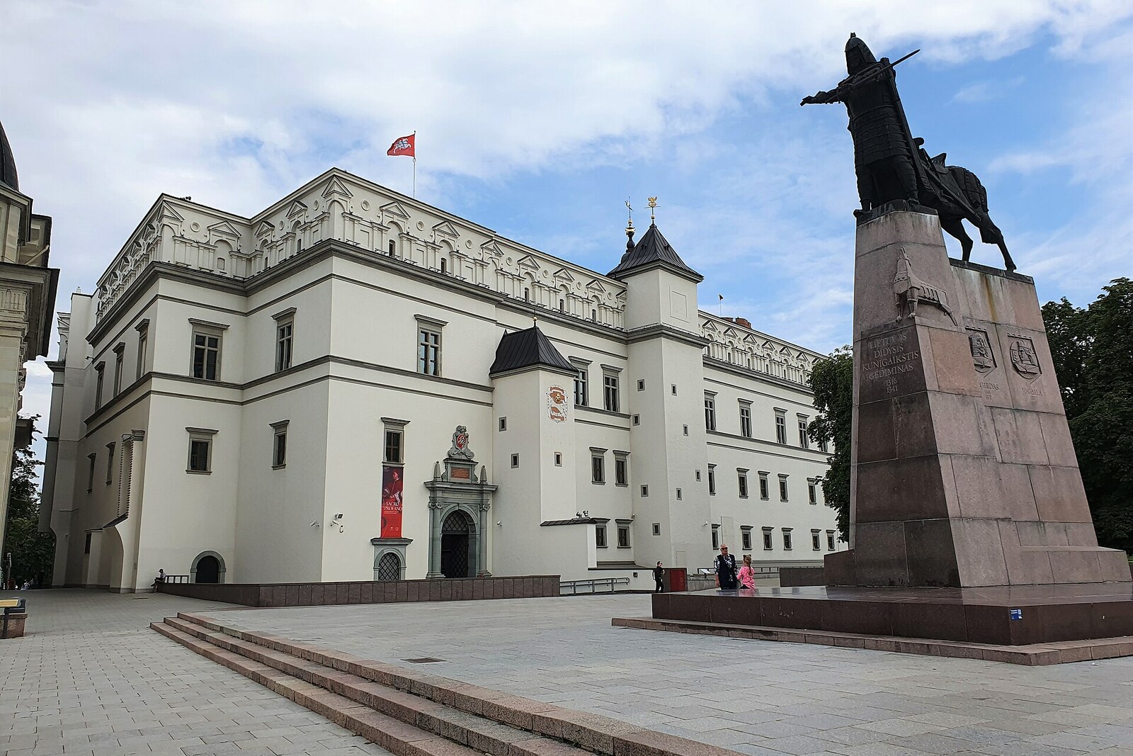 The Monument to Gediminas beside a horse and the pale Palace of the Grand Dukes of Lithuania.