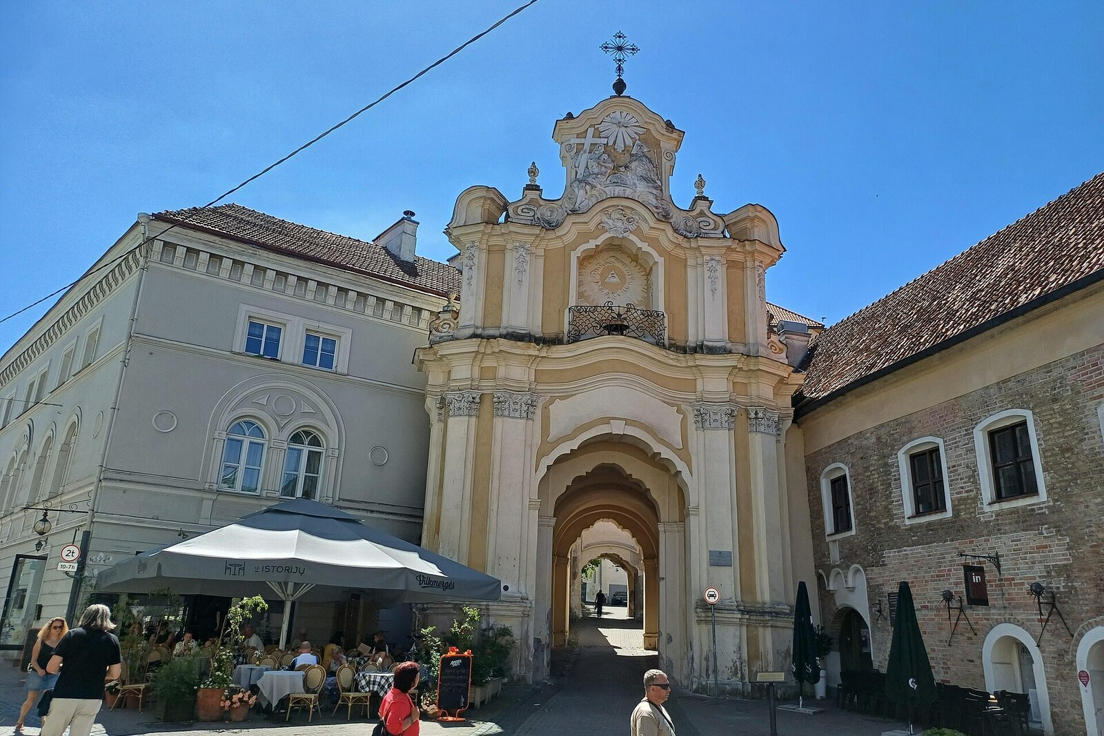 The light-yellow Basilian Gate with an ornate top and an arched passageway.