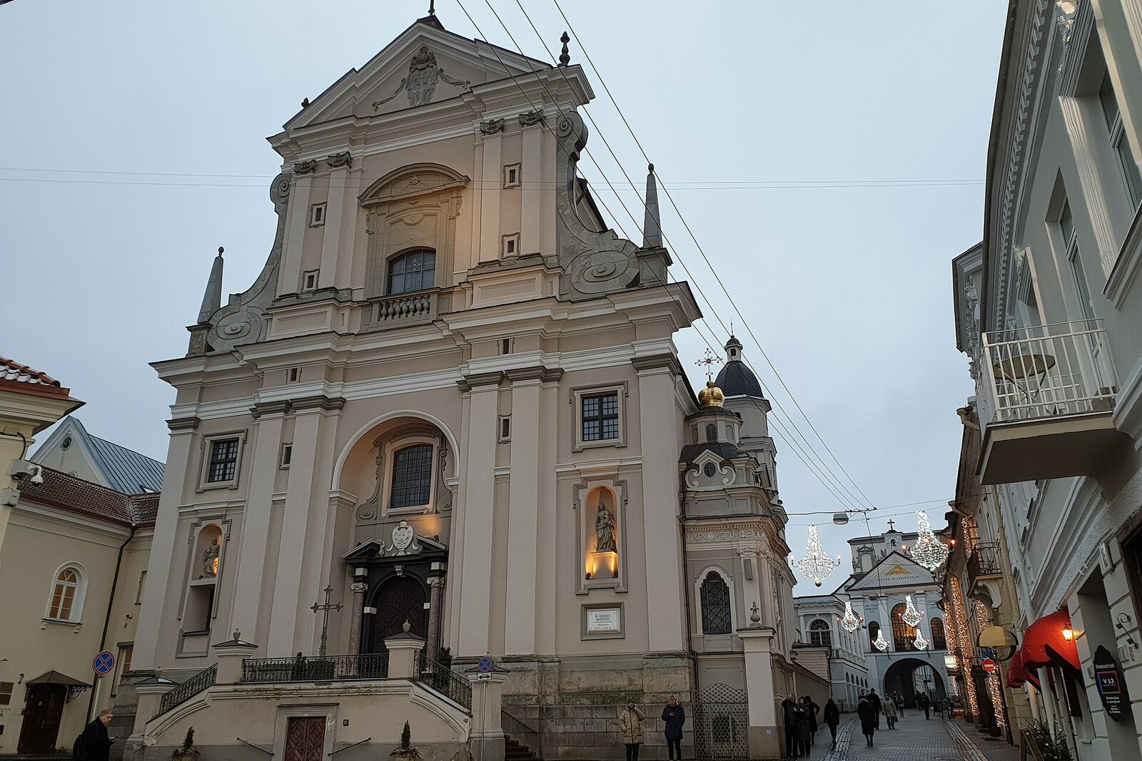 The Baroque facade of the Church of St Teresa on a narrow street in Vilnius.