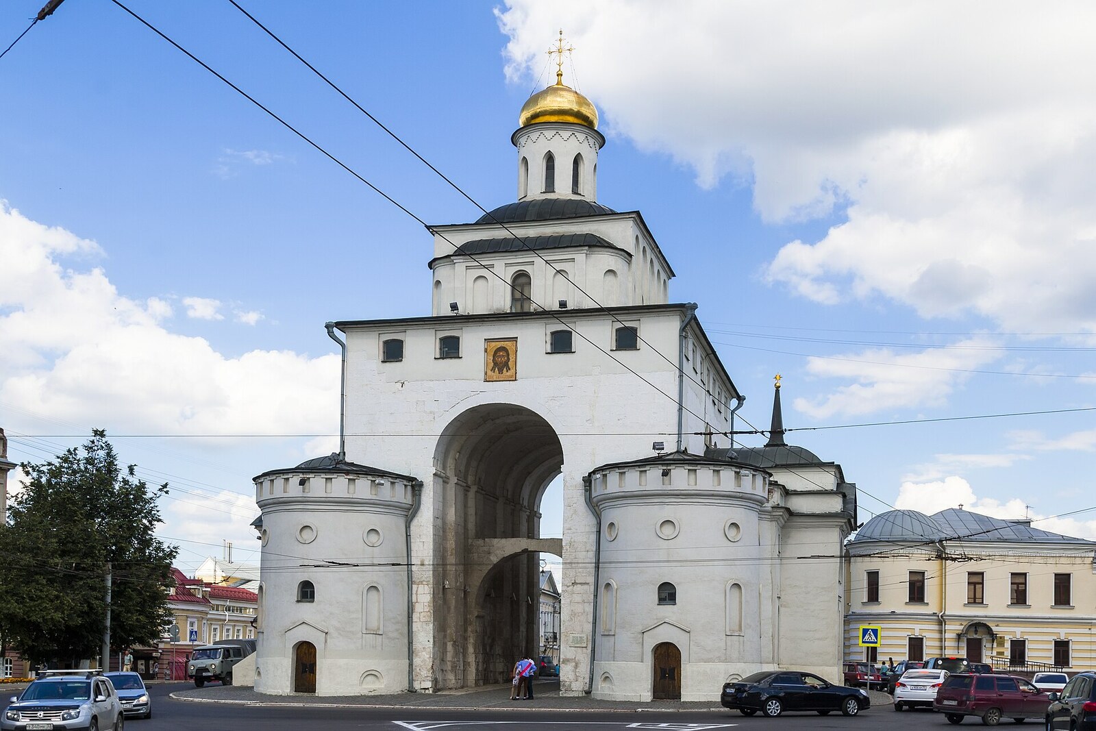 Vladimir’s Golden Gate before restoration, with a view of the white-stone arch and the church above.