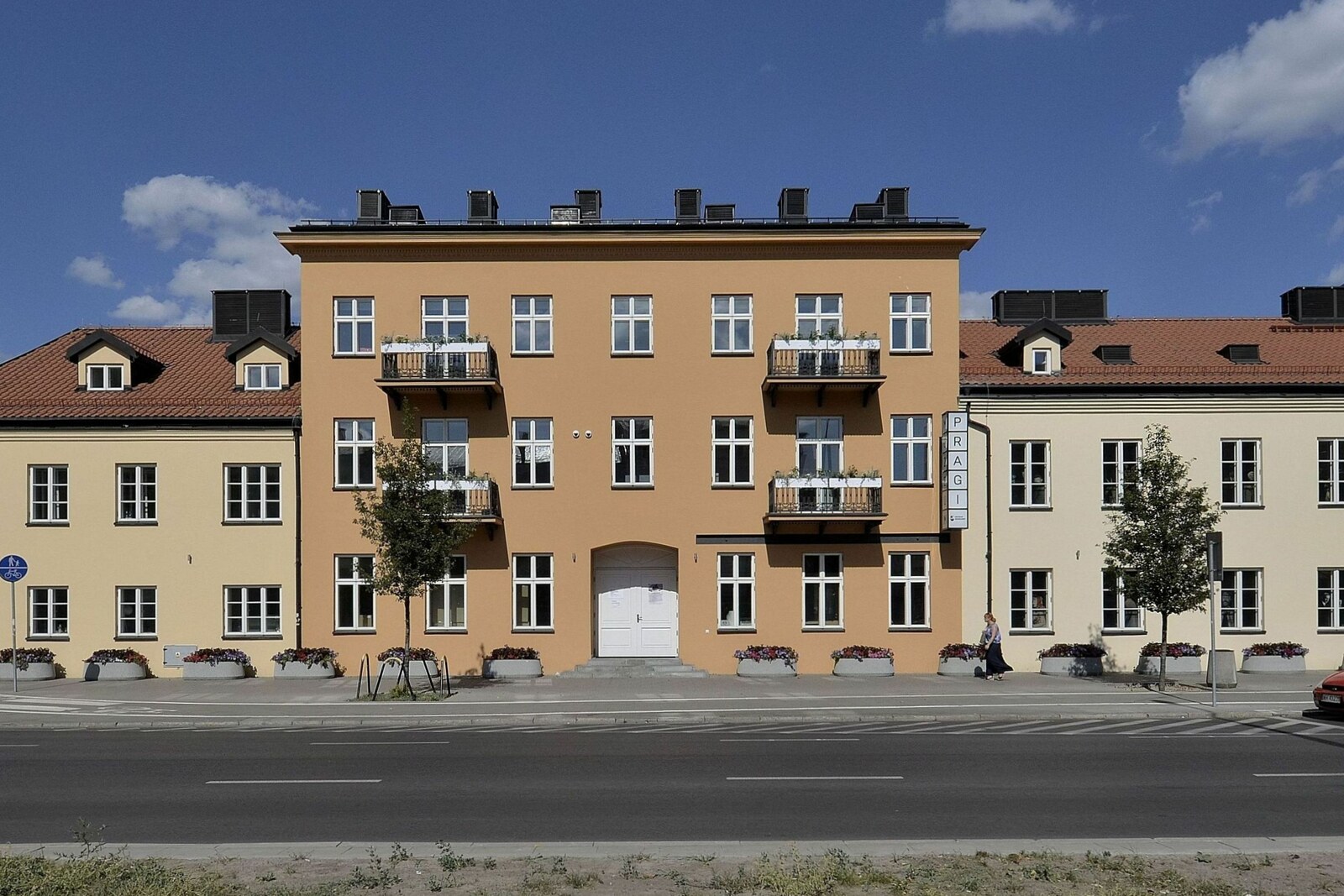 A red-brick house with wooden galleries — the Museum of Praga