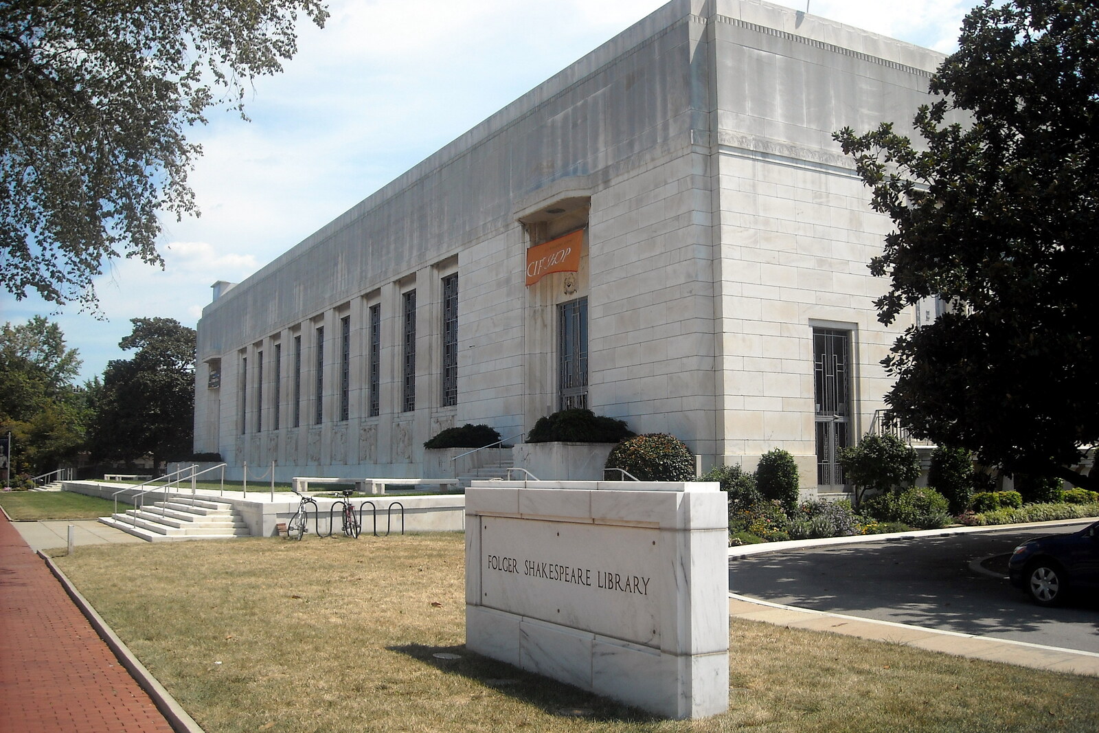 The low white Folger Shakespeare Library building with carved bas-reliefs and inscriptions.