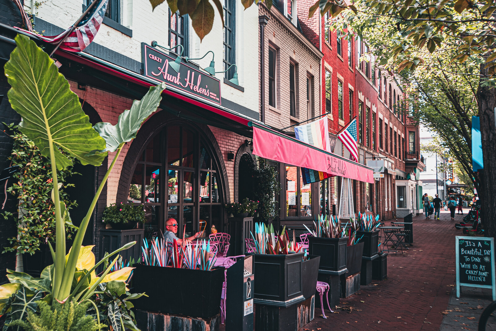 Pedestrians walk along 8th Street SE, with restaurants and shops on both sides.