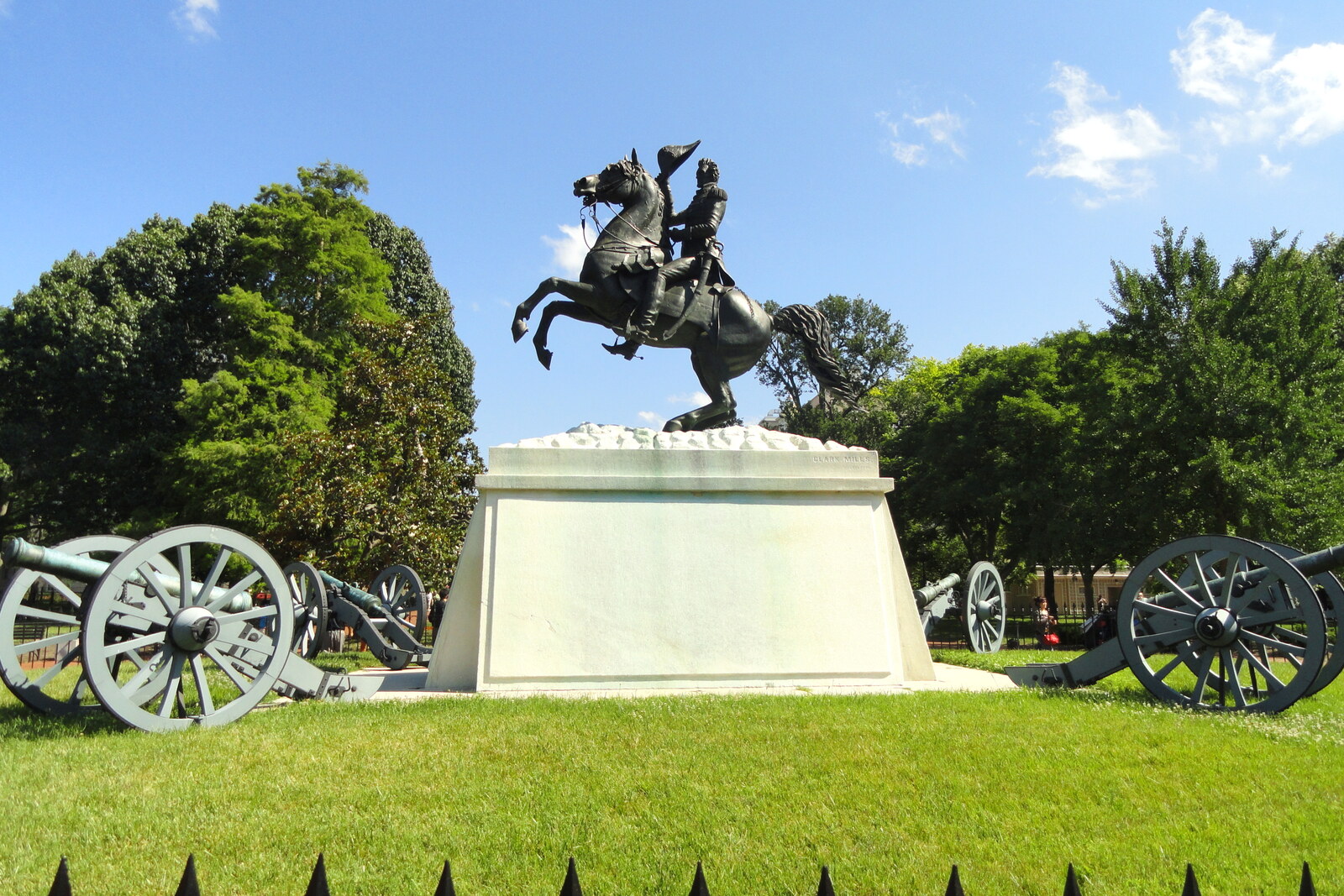 The bronze equestrian statue of Andrew Jackson against green trees in Lafayette Square.