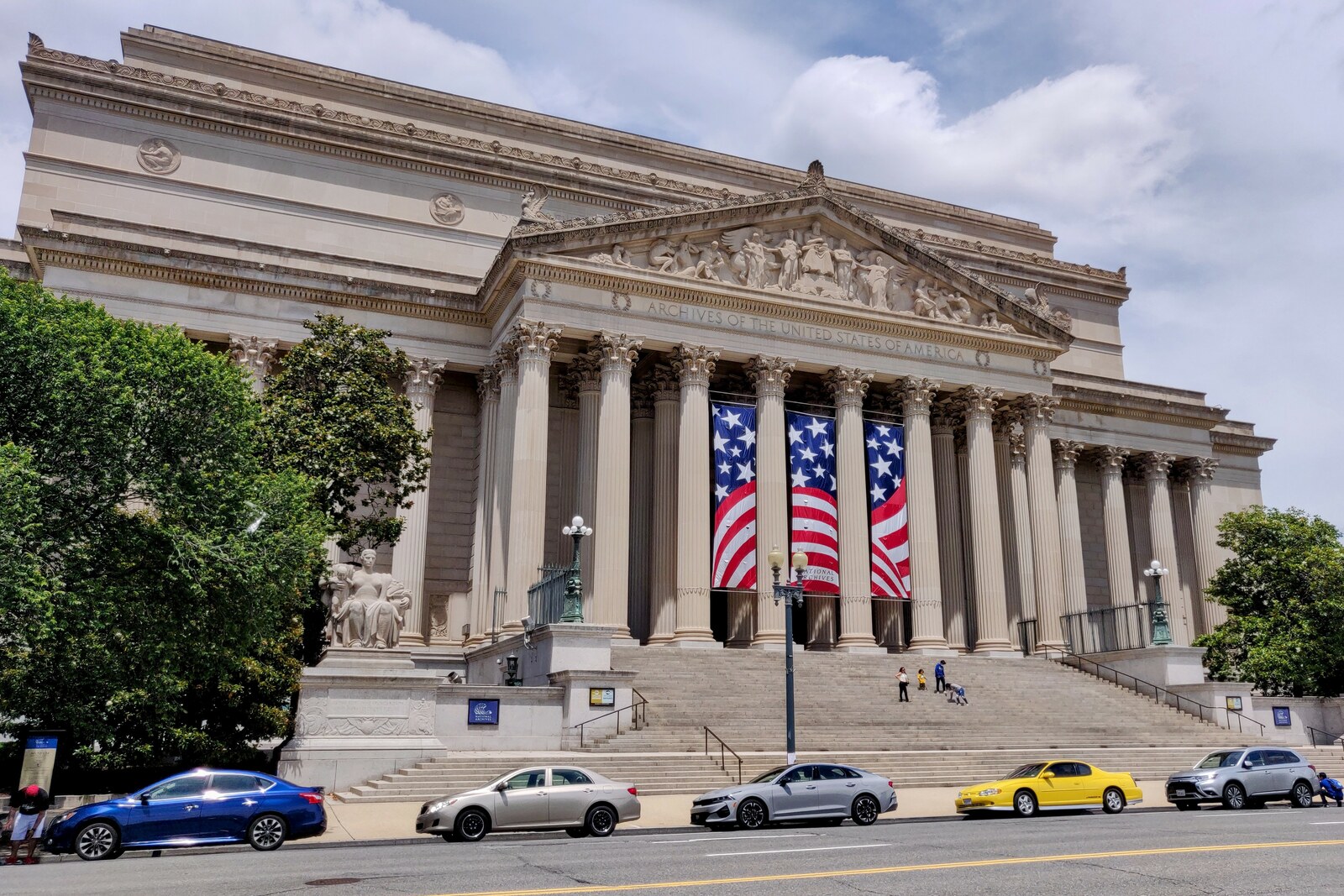 Neoclassical facade of the National Archives Building with broad steps and columns.