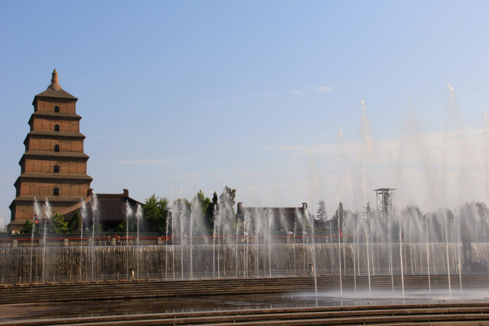 View of the North Square of Giant Wild Goose Pagoda: the musical fountain sends up jets of water in front of the brick pagoda.